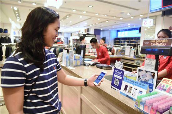 2017年11月11日，在菲律宾马尼拉一家商场，消费者使用GCash电子支付系统付款。与阿里巴巴合作的GCash被称作“菲律宾版支付宝”。新华社记者秦晴摄